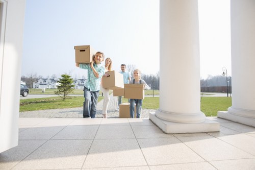 Professional home moving service in Barbican with packed boxes and furniture