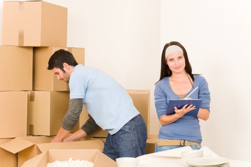 Preparing boxes and furniture for a moving van in Barbican
